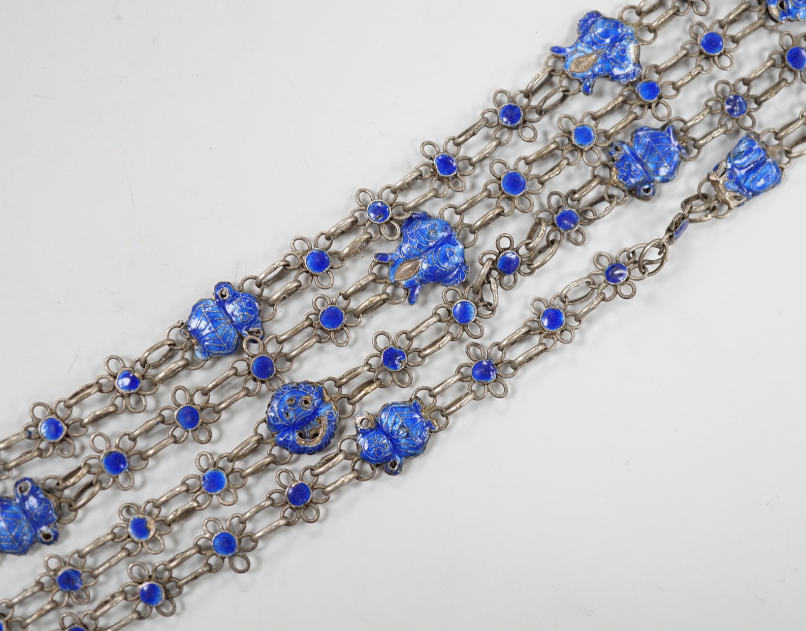 A long Chinese white metal and blue enamel set drop necklace, 204cm.